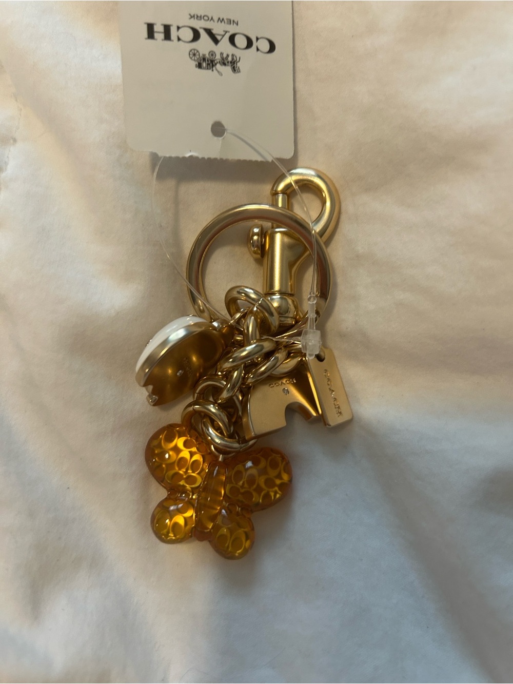 Coach Gold Hardware Keychain with Amber Butterfly and White Ladybug